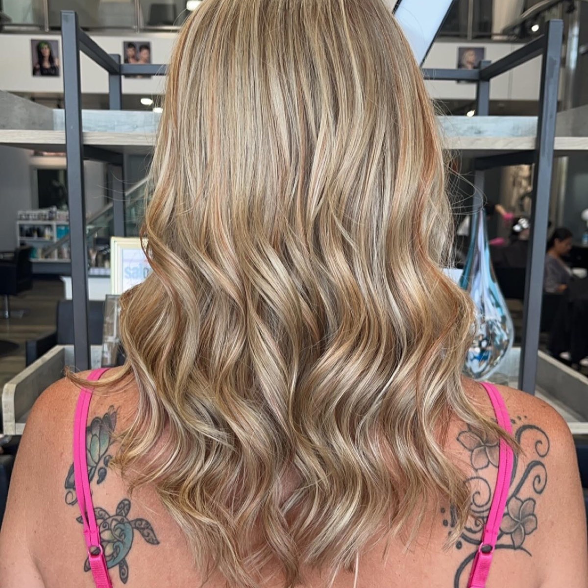 Shoulder-length blonde highlights curled into soft waves