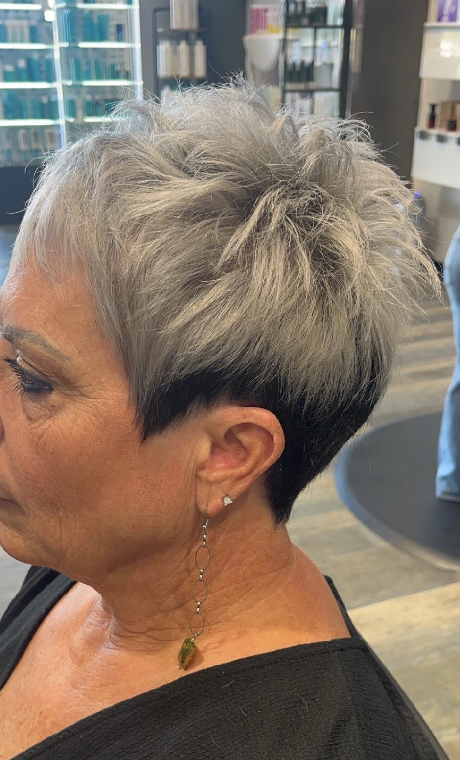 Short silver pixie cut with a dark under-section, textured on top